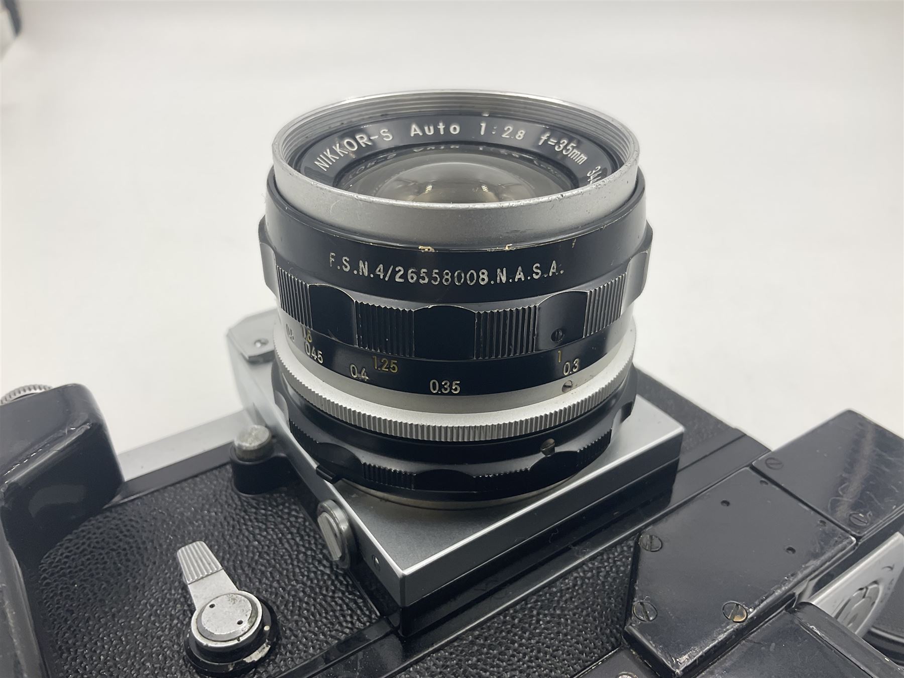 Nikon F NKJ plain prism camera body, serial no. 6520477, with 'Nikon NIKKOR-S Auto 1:2.8 f=35mm' lens, serial no. 344731, Nikon F36 Motor Drive NKJ, serial no. 122780 and Nikon cordless battery pack