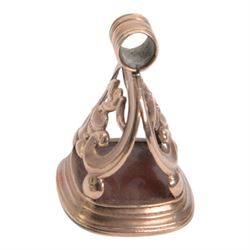 Late 18th/early 19th century 9ct gold fob seal, the carnelian matrix engraved with coat of arms, depicting a shield surmounted by a bird with foliage within its beak, within a scrolling mount detailed with a bird drinking from a chalice, H3.5cm 

Provenance: By family descent from the Chichesters of Arlington Court, Devon; from the collection of Andrew Chichester Everitt.