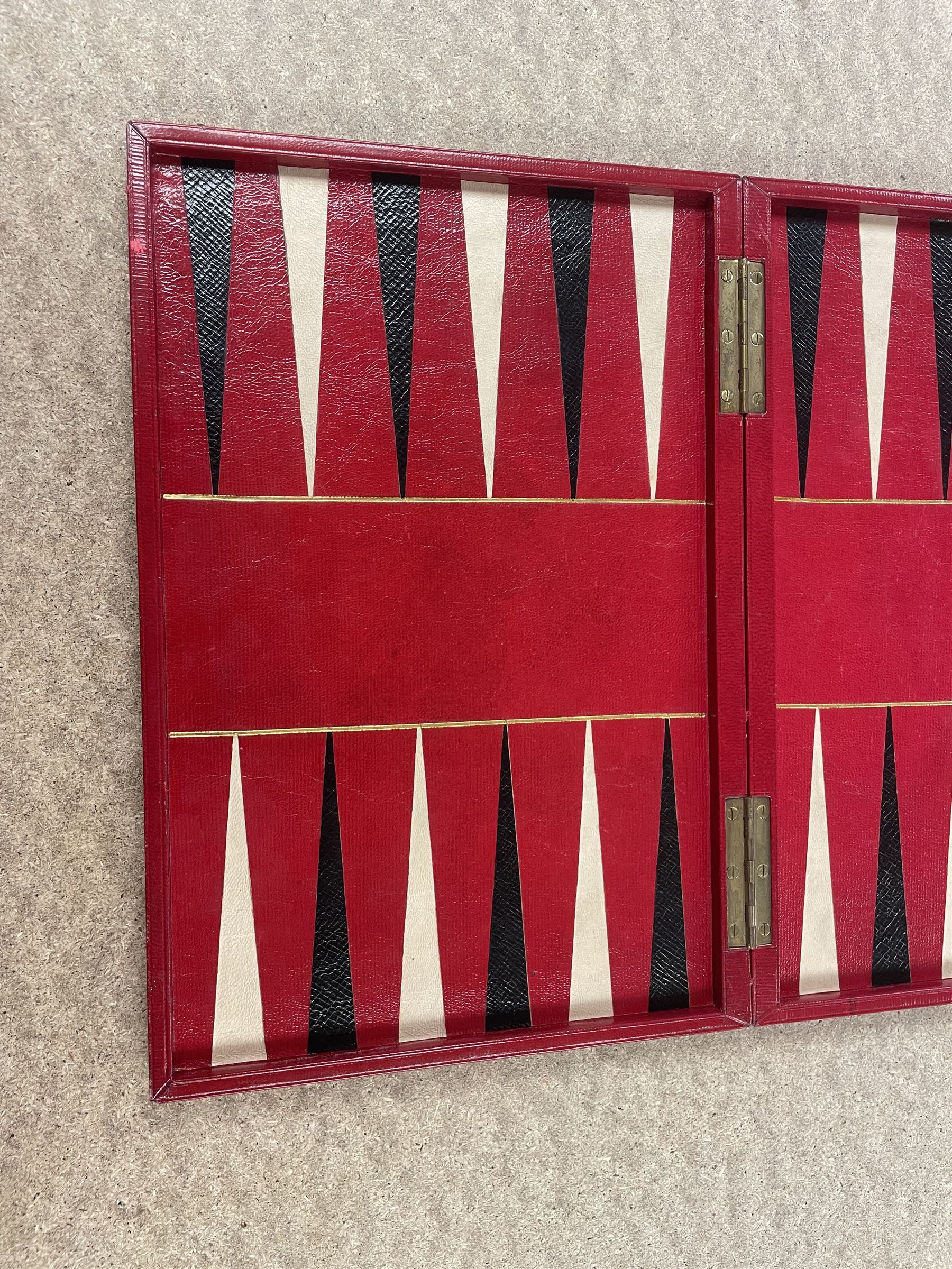 19th century walnut and brass bound games compendium box, painted to enhance the grain, of rectangular form, the hinged opening cover with rounded sides, central brass cartouche with engraved lion crest, and brass riveted straps, opening to reveal a red leather and blue silk lined compartmented interior, with fold-down games board, and lift-out tray containing playing cards, ebony turned dice towers, white and red stained bone draughts, and chess pieces, ivory dice, and ivory and ebony whist markers, and brass bezique board, cribbage board and markers, H15cm W32cm D24cm
This lot has been registered for sale under Section 10 of the APHA Ivory Act