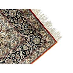 Persian silk finely knotted rug, central floral rosette medallion surrounded by curling branches decorated with palmettes, repeating pattern borders decorated with stylised plants and trailing leafy branches  