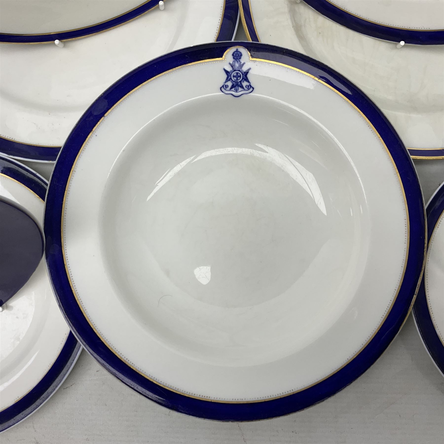 Collection of Regimental dinner wares, Comprising Royal Sussex; two dinner plates, two side plates and a soup bowl, Royal Leicestershire; two dinner plates, East Yorkshire Regiment side plate and Gordon Highlanders side plate, all decorated with the regiment's crests and blue and gilt boarders (9)