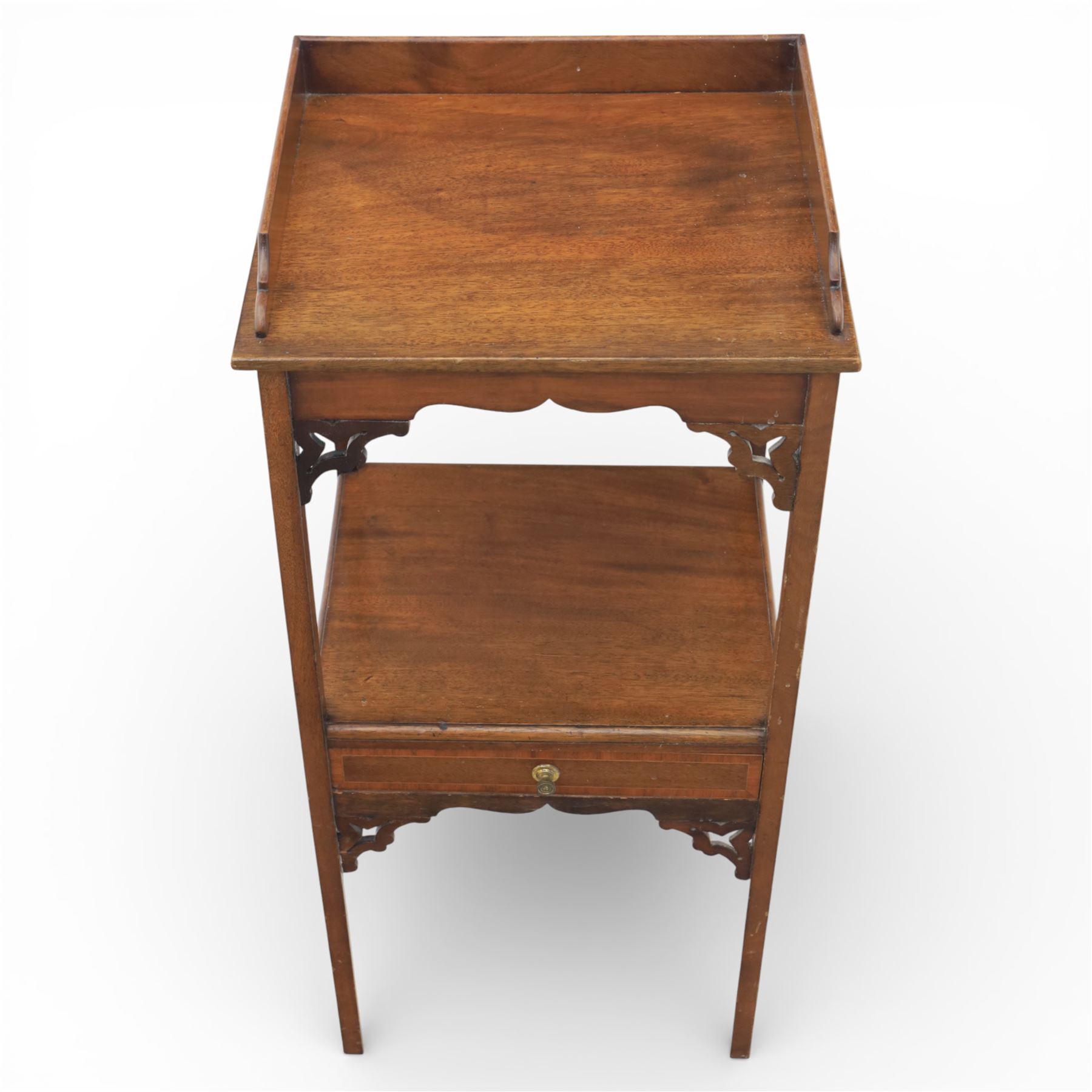 George III mahogany two tier night stand, rectangular tray top with three quarter gallery and shaped cut corners, pierced fret brackets to the apron, fitted with a single drawer to the lower tier, raised on slender square section legs