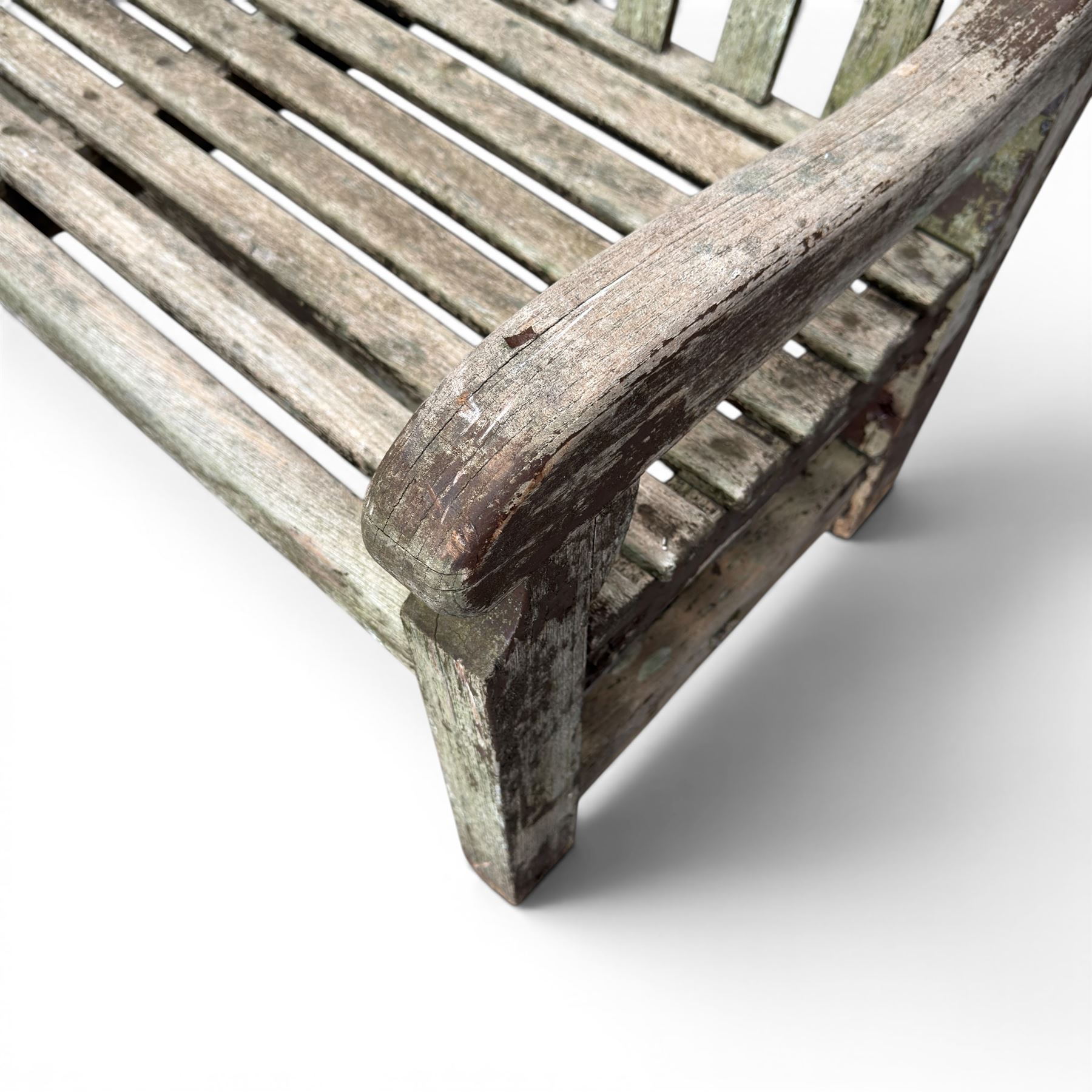 Teak garden bench with slatted back and seat raised on square supports