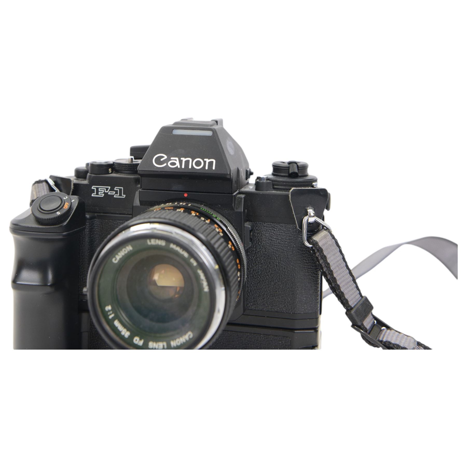 Canon F1 camera body, serial no. 223511, with 'Canon FD 35mm 1:2 FD' lens, serial no.23164, shoulder strap and Canon AE Power winder, serial no.174705