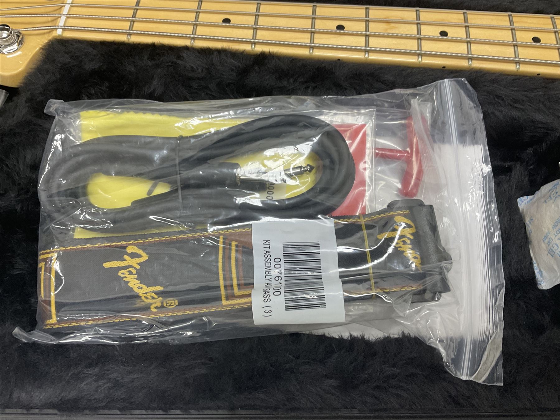 Fender Precision Bass guitar, in Olympic White finish with tortoiseshell effect scratchboard, serial no US15103092, in black Fender hard case with Fender strap and warranty card, guitar L116cm