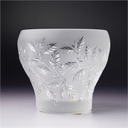 Three Lalique frosted glass tea light holders, decorated with the coriander and basil patterns, and another with trailing leaves, marked Lalique France to base, H7.5cm