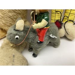 Deans Rag Book Mickey Mouse soft toy, circa 1930's, black velveteen head and body, with cream face and hands, red shorts and yellow felt shoes with leather soles, marked Reg. No. 750811 to neck H20cm; mid-20th century woodwool filled plush covered teddy bear with revolving head, applied eyes, vertically stitched nose and mouth and jointed limbs H52cm; soft toy figure of Rupert Bear; and Japanese clockwork tin-plate and plush covered mechanical toy of a gnome riding a donkey (4)