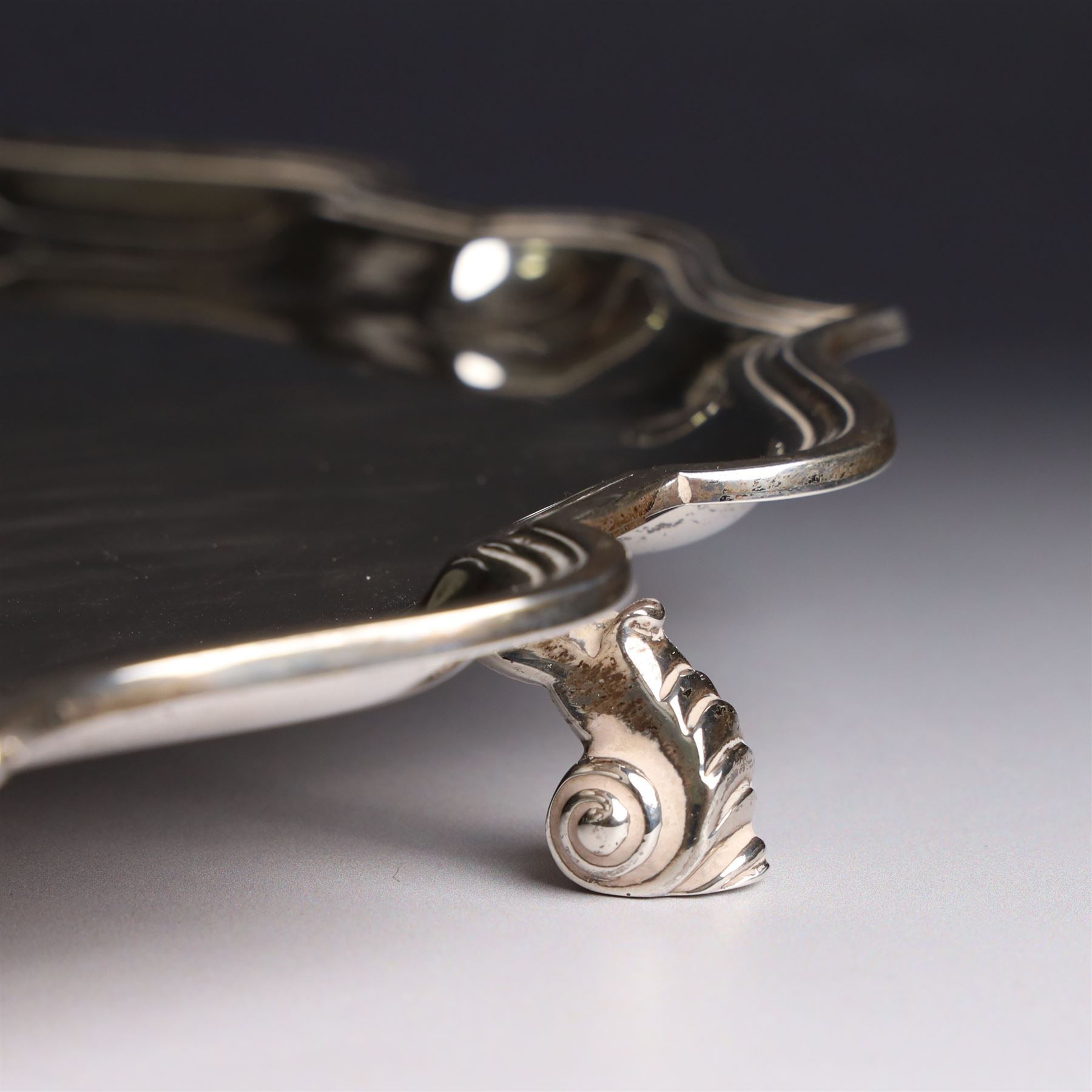 Mid 20th century silver tray, with shaped rim and upon three scroll feet, William Suckling Ltd, Birmingham 1946, D36cm