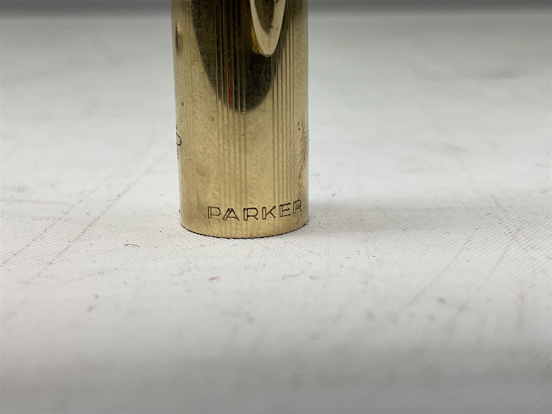 9ct gold propelling pencil with engine turned decoration and vacant cartouche, by S J Rose & Son, stamped 375, L12cm, together with a Parker 12ct rolled gold fountain pen, and two rose gold engine turned propelling pencils to include a rose gold example