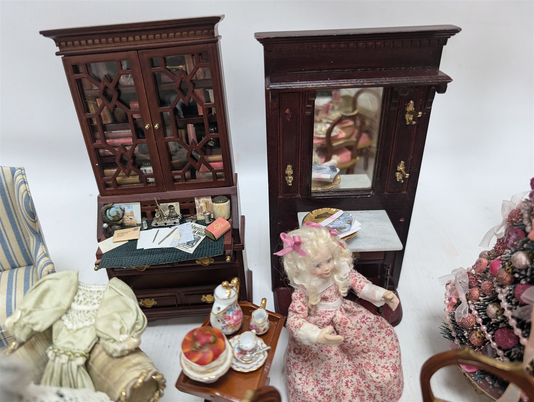 Dolls house living room and ding room furniture, including sofa, chair, long case clock, Christmas trees, fireplace, dresser, chairs, tables, mirrors, seven figures and a collection of predominantly Christmas themed decorations, food, etc