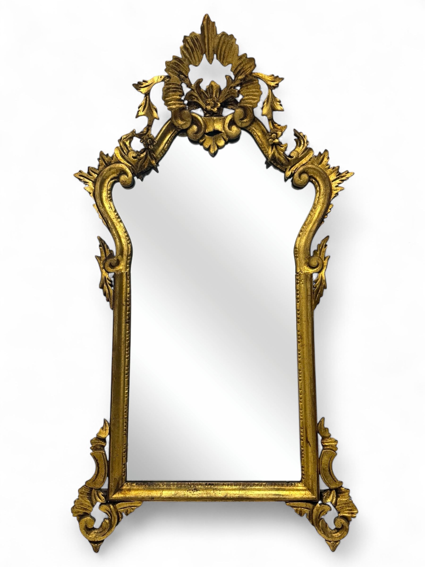 18th century design gilt framed wall mirror, within a pierced and scrolling foliate frame, leaf sprays and flowerhead cresting