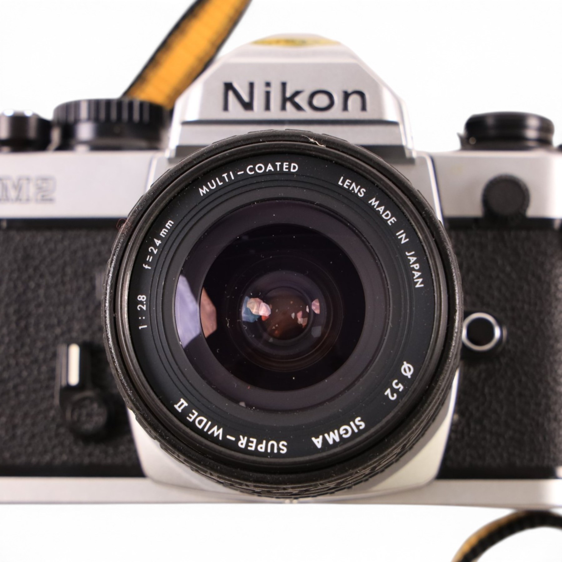 Nikon FM2 film camera body serial no. 7814849 with a Sigma 24mm lens serial no.5083190, camera user manual and Nikon carrying case