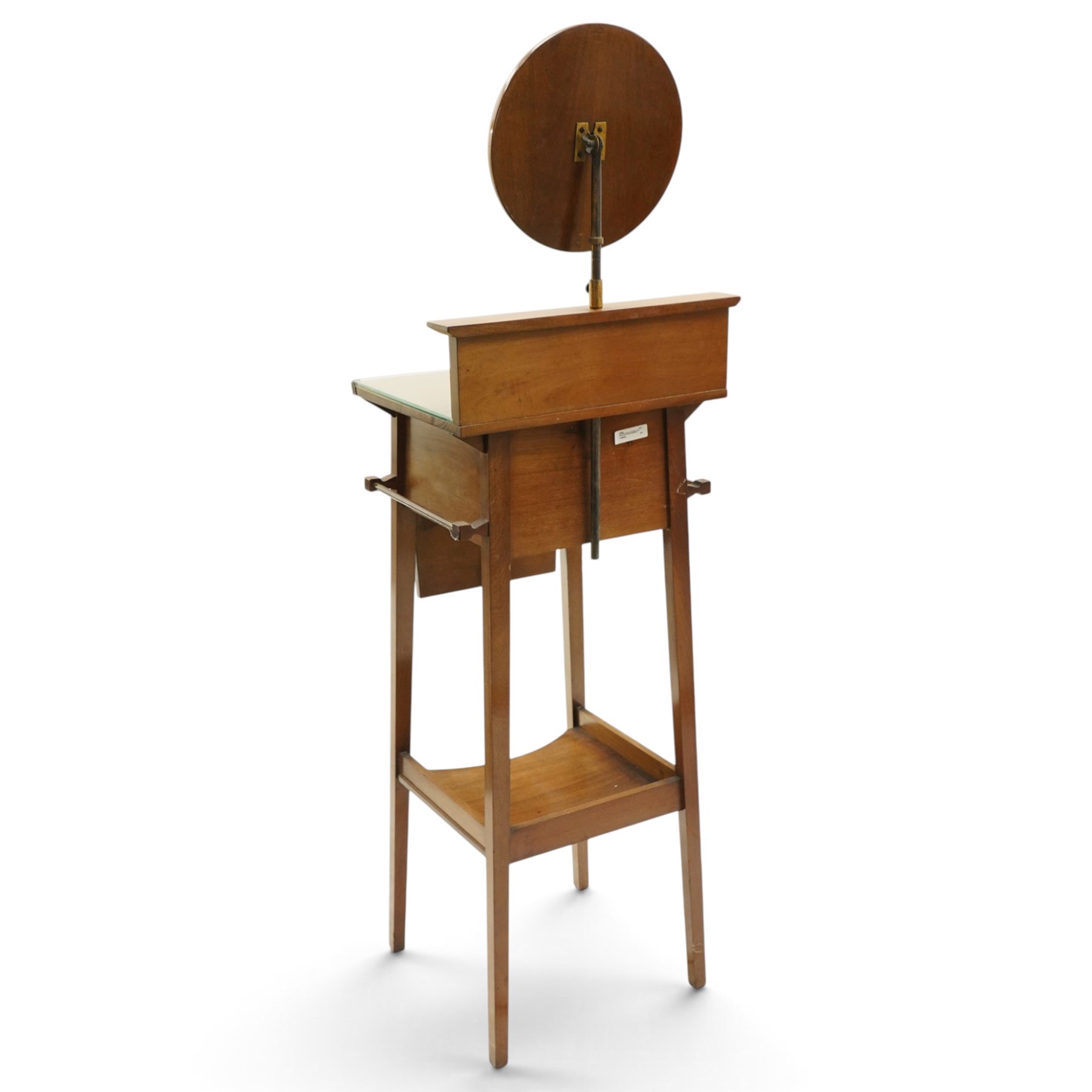 Early 20th century oak valet stand, raised back withy circular swivel mirror, over fall front compartment, raised on square supports united by concave under-tier