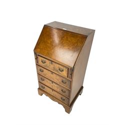 Mid-20th century Georgian design figured walnut bureau, the fall front enclosing small drawers and pigeon holes, fitted with four drawers, on bracket supports