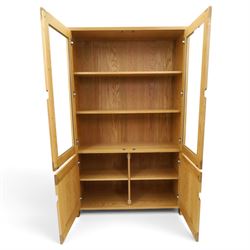 Ercol - contemporary oak 'Bosco' display cabinet, fitted with two shelves enclosed by glazed doors, over two cupboard doors, raised on stile feet