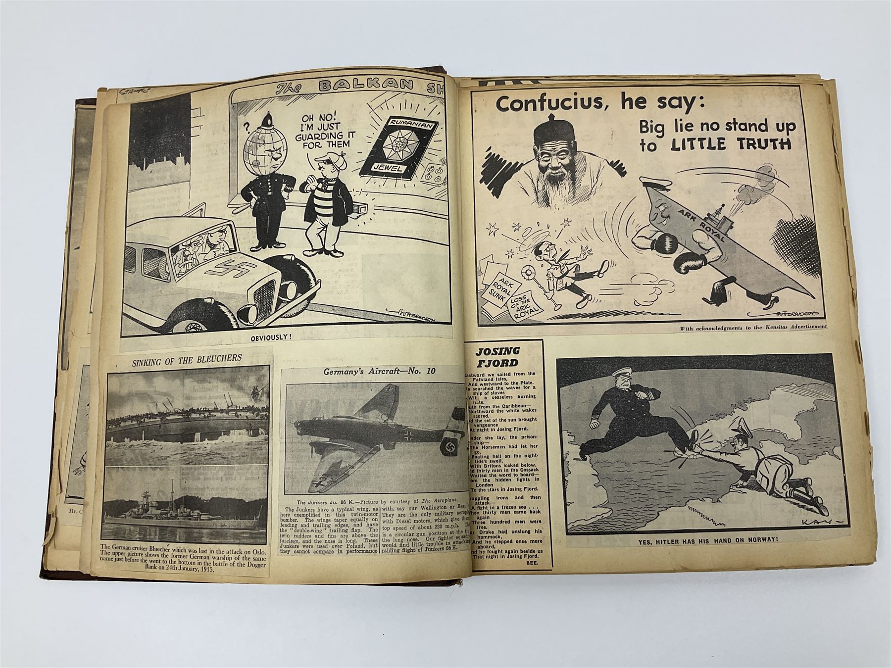 Album of WWII era paper ephemera, to include cartoon illustrations by George Goodwin Butterworth and Clive Uptton, articles and photographs