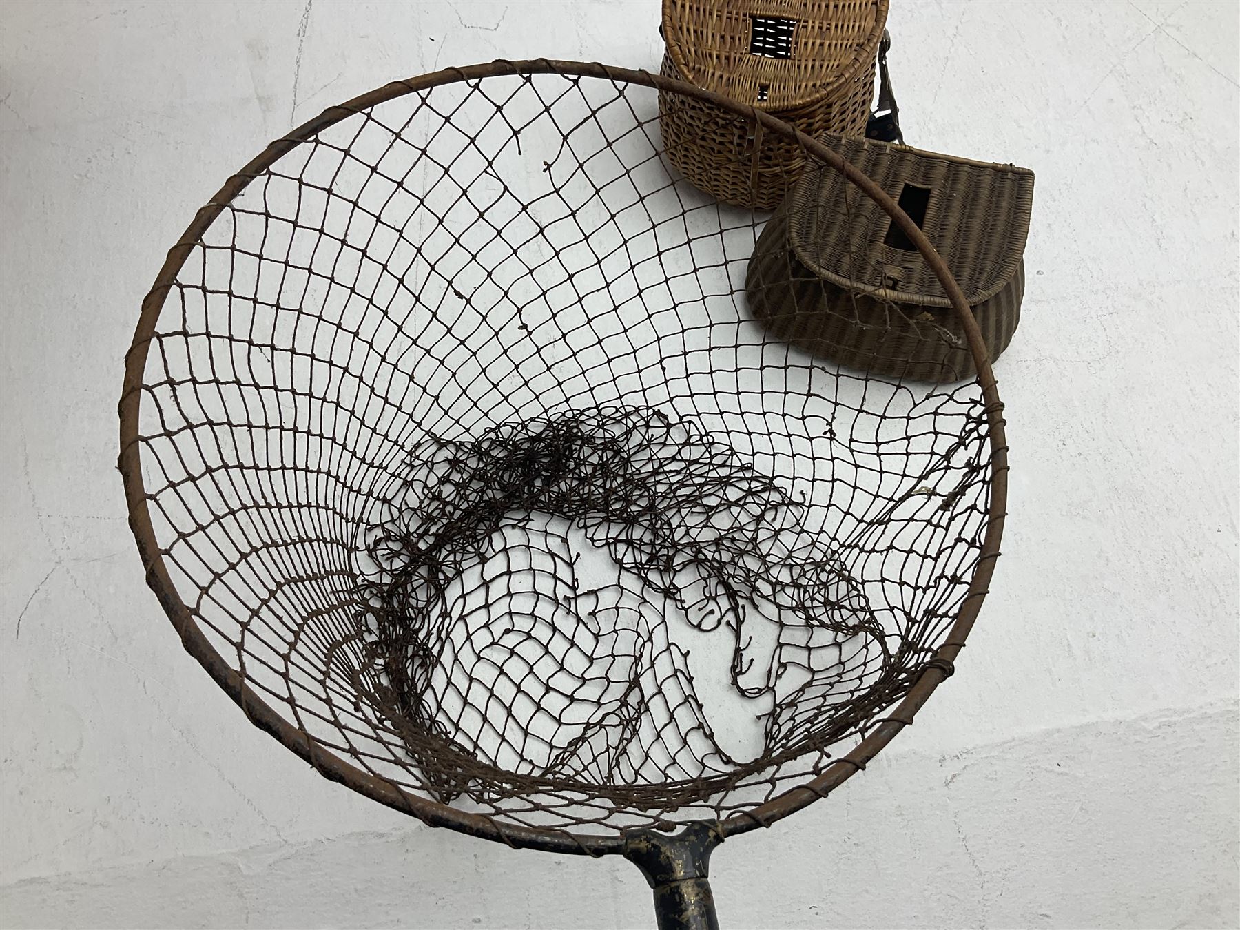 Fishing tackle and accessories housed in two wicker creels, including a landing net, fly tin, small brass reel, other reels to include two Intrepid Boy'o examples, crab lines etc 