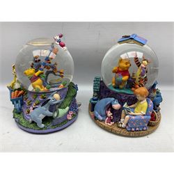 Five Disney Winnie The Pooh snow globes, to include Pooh and Piglet Sailing, Pooh's Grand Adventure and Blustery Day, together with The Walt Disney Classic Waterglobe collection globe and group Tigger, Winnie and Piglet figure under dome, all with boxes (7)