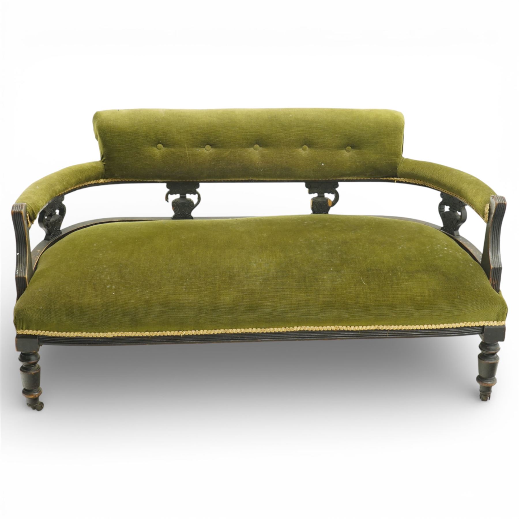 Late 19th century upholstered settee, shaped padded back with a row of button detailing, downswept open arms with upholstered pads, upholstered in olive green velvet, the frame with moulded rails and raised on turned front supports and out-swept rear legs with castors