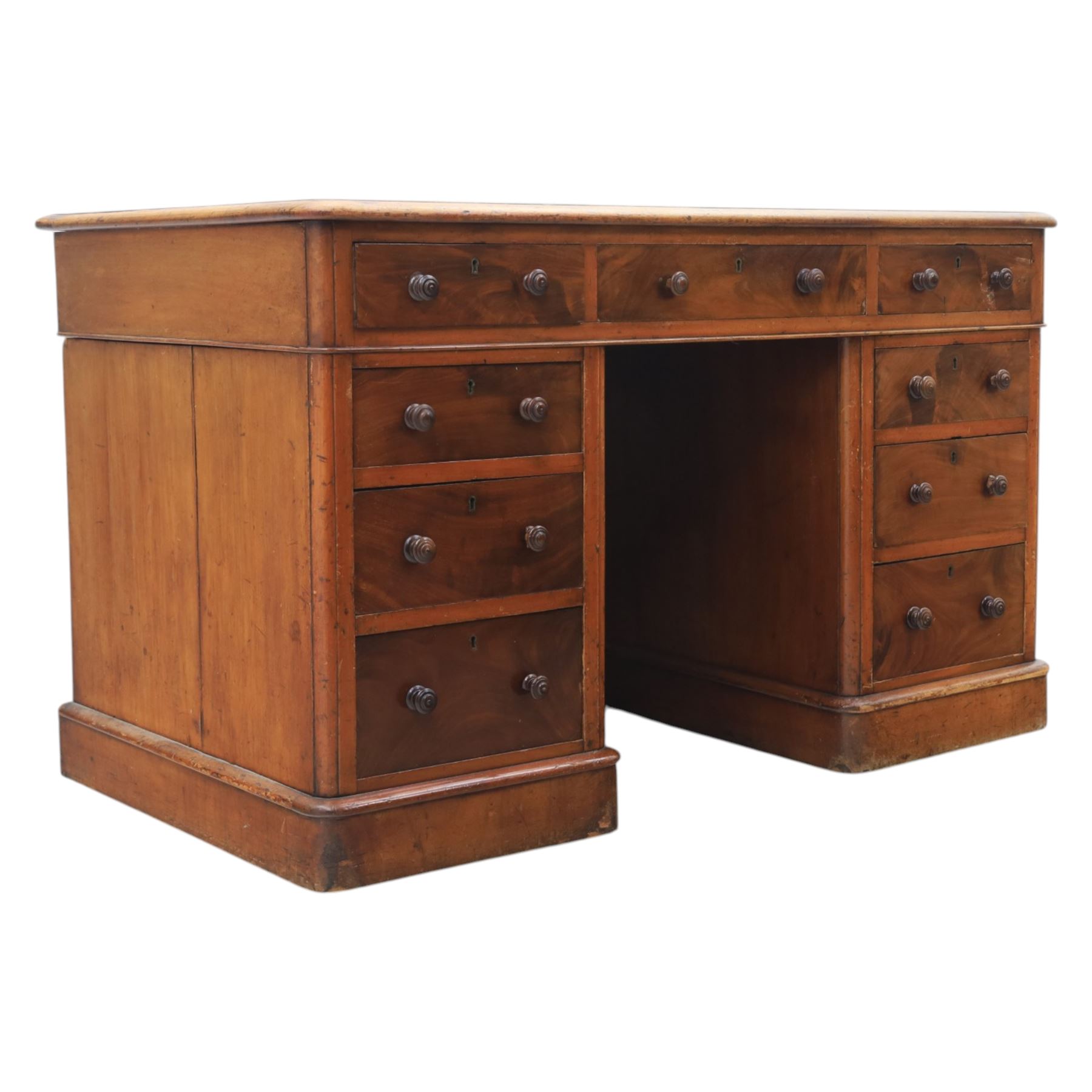 Victorian mahogany writing desk, featuring inset tooled red leather top, raised on two pedestals, nine drawers with figured veneer fronts