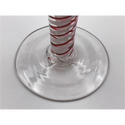 18th century drinking glass, the ovoid form upon  a colour twist stem with alternating red and white spirals surrounding a white fine spiral gauze, and conical foot, H13cm


