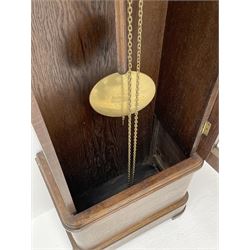 Early 20th century Art Deco oak longcase clock, circular dial with roman numerals and minute track, dial signed 'Barnby & Rust, Hull', twin chain driven movement striking the hours on gong rods. With weights and Pendulum.