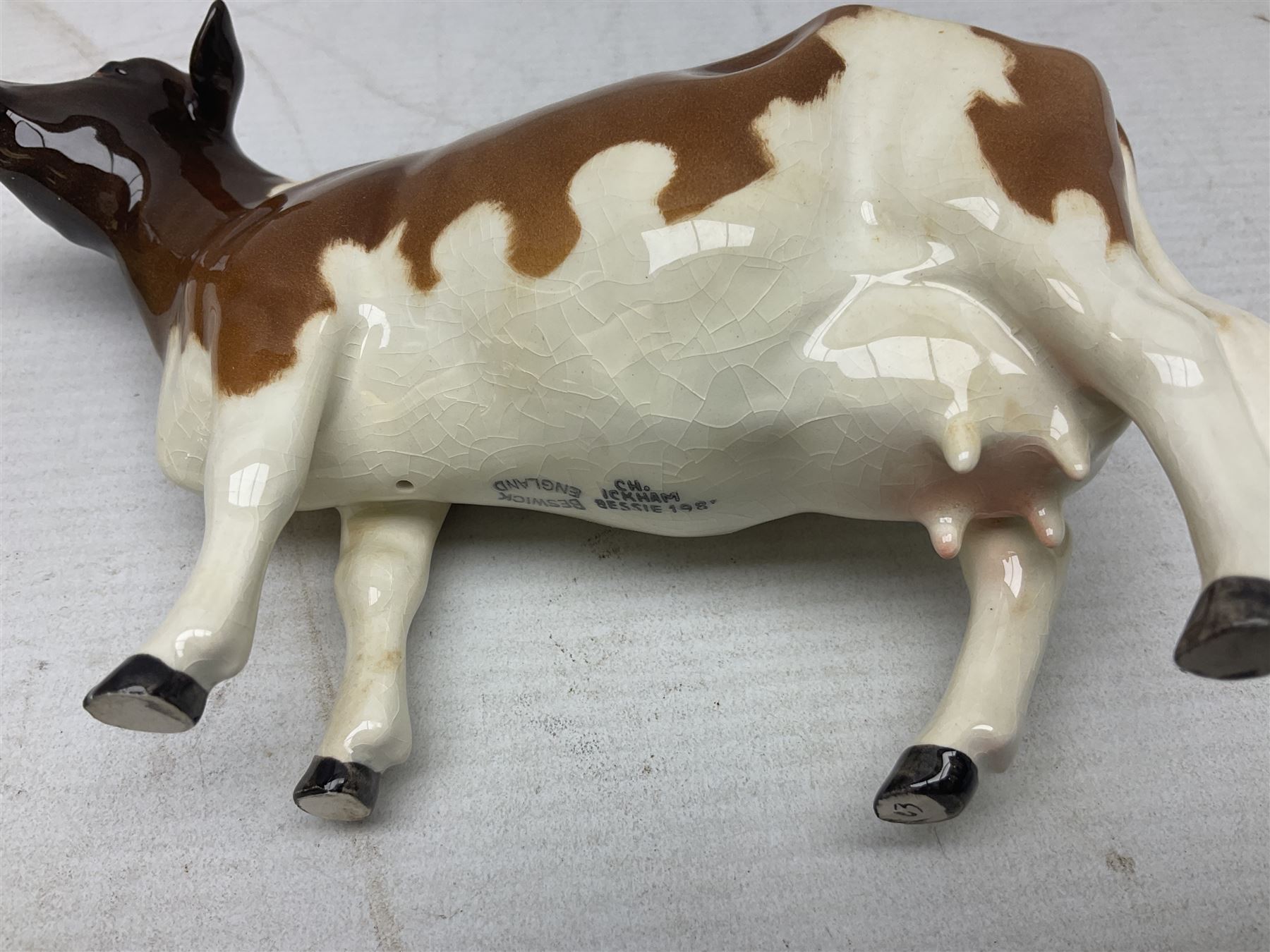 Five Beswick figures of cattle Comprising Ayrshire Bull Ch Whitehill Mandate, no 1454B, three Ayrshire Cow Ch Ickham Bessie, no 1350 and Ayrshire Calf, no 1249B, all with printed marks beneath