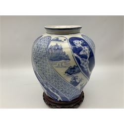 Chinese blue and white vase, the ovoid body of wrythen form decorated with panels of figures and hut scenes and geometric design, with character mark beneath, upon carved hardwood stand, H30cm