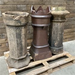 Collection of three Victorian and early 20th century reclaimed terracotta chimney pots, comprising: one cylindrical form with weathered, cracked glaze and flared octagonal base; one deep red cylindrical pot with fluted midsection and castellated rim, bearing moulded number ‘25’; and one tapering hexagonal example with wide flared rim and weathered patina. All with age-related wear and chips, consistent with use and outdoor exposure. Plus a selection of cast stone pieces including fountain 