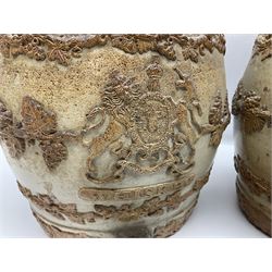 Two 19th century stoneware barrels, one for gin and the other for whisky, decorated in relief with lions, grape vines, armorial crests and mounted figures, H31cm