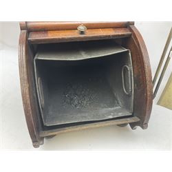 Victorian mahogany coal scuttle, the domed rolling lid carved with ornate foliate motifs opening to reveal interior with twin handled liner, mounted with carrying handle and shovel, together with brass fireside tools, largest H46cm