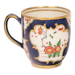 18th century Worcester coffee cup and saucer, circa 1770,  painted with shaped panels of chrysanthemums and banded hedges on a blue scale ground with gilt detail to the rim, mark beneath, H8cm 