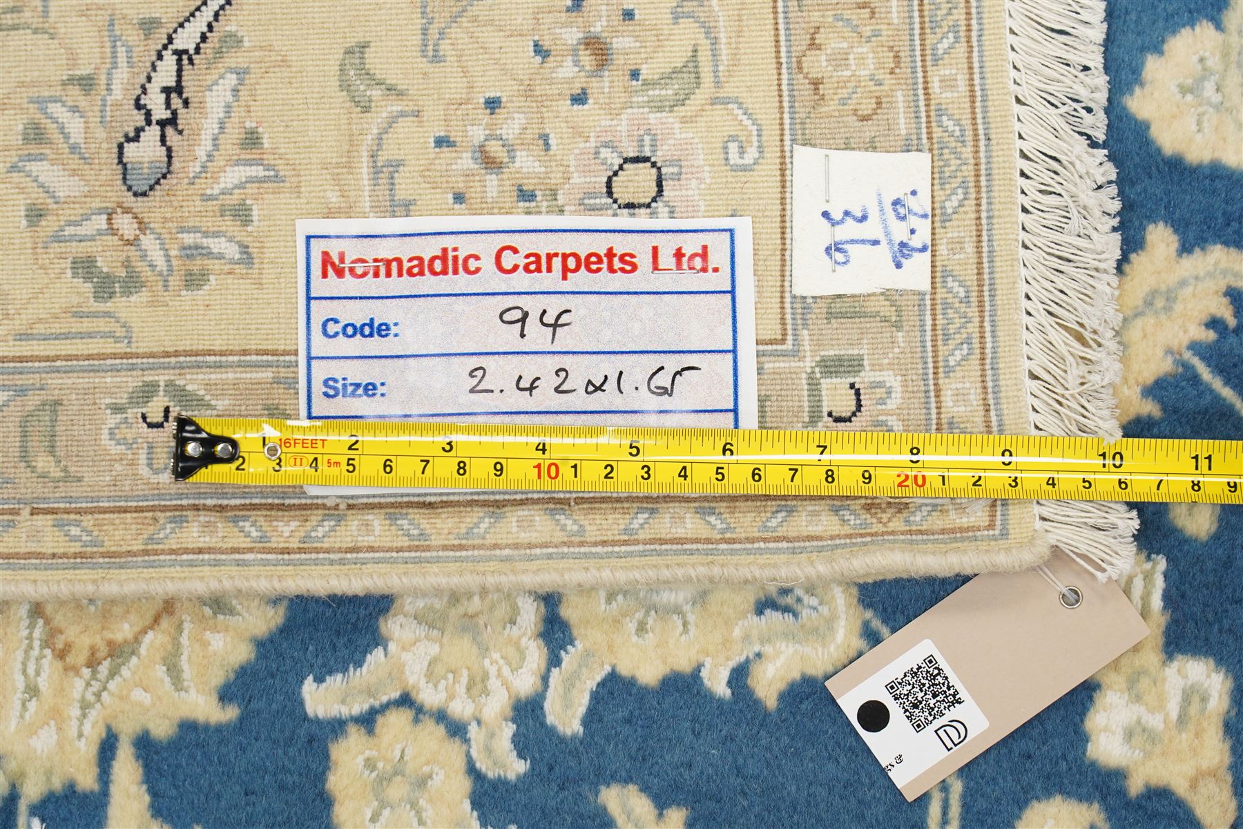 Central Persian Nain hand-knotted rug, sky blue field, with a central cusped medallion in ivory and soft camel tones, issuing an elegant arrangement of scrolling arabesques, palmettes and flowering vines, conforming ivory spandrels, principal pale border decorated with floral sprays and palmettes, flanked by narrow ground borders, with cotton fringe ends  