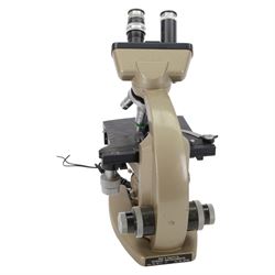 Three microscopes, including Griffin Student Vernier Microscope, Vickers Instruments binocular microscope with Leitz Wetzlar Periplan 10x lenses, and a Carl Zeiss Jena binocular microscope in a wooden Olympus Tokyo box