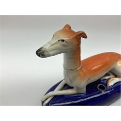 Pair of Staffordshire recumbent greyhound pen holders 