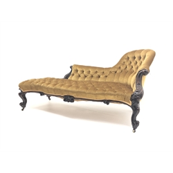  Victorian walnut framed chaise lounge, with carved scrolled acanthus leaf arm terminals, upholstered in deep buttoned yellow velvet, scroll carved apron and cabriole legs with brass castors,  W198cm  