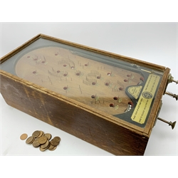 Early 20th century table top bagatelle game 'The Advance Pin Table - British Made - For Amusement Only',  in oak case with glazed top and coin operated mechanism with quantity of pre-decimal pennies 30 x 64cm