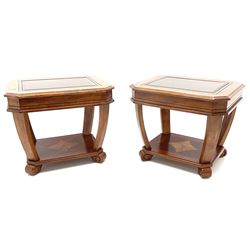 Pair walnut rectangular two tier lamp tables with inset glass tops, shaped supports joined by cross banded and inlaid undertier, raised on carved block supports 