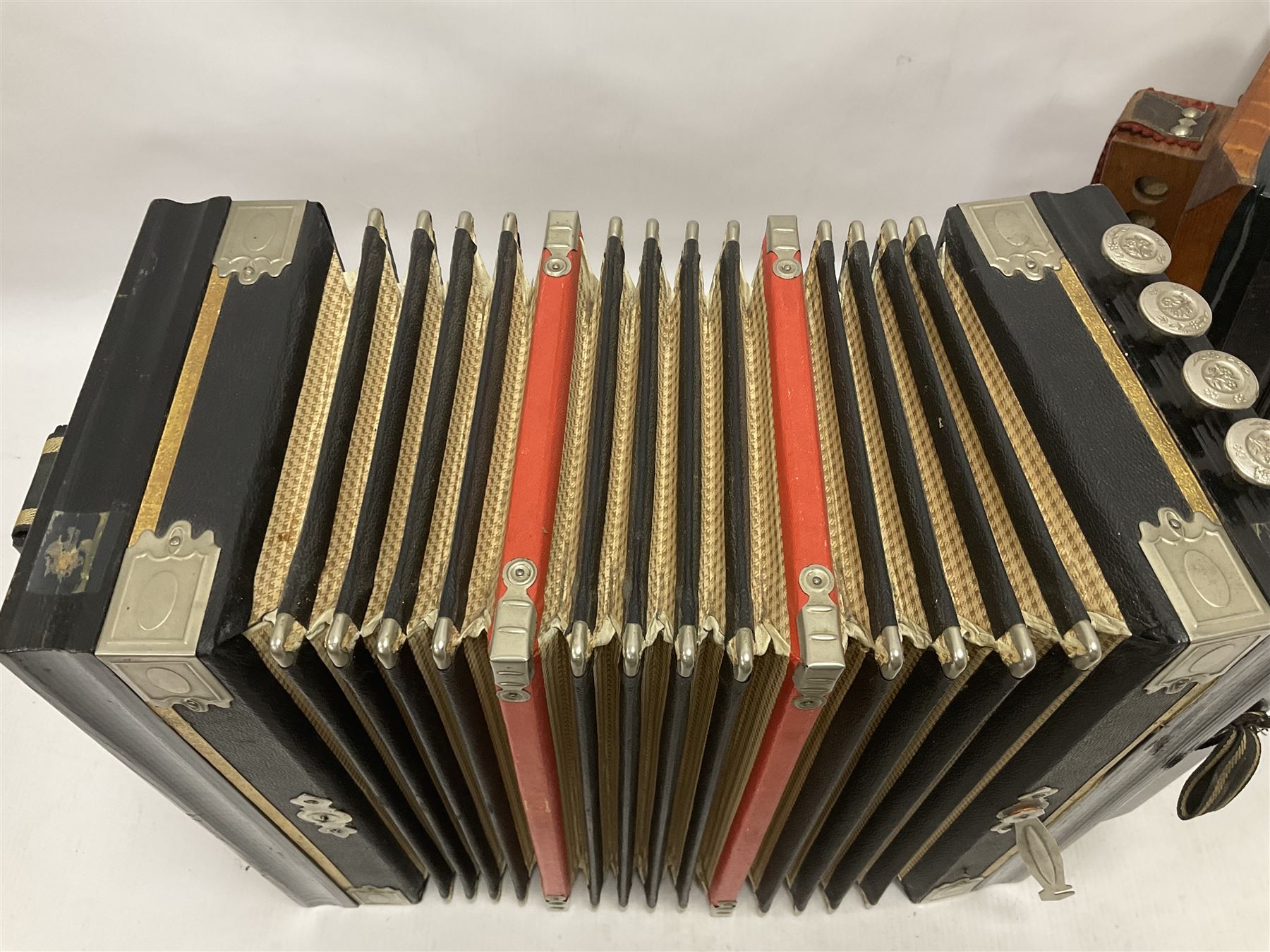 Three European concertinas, comprising Viceroy German concertina with 21 keys, hexagon wooden frame and 8 fold bellows
Oak framed concertina with 12 keys and 8 fold bellows
Commander concertina with 12 keys and 12 fold bellows
With tutor
