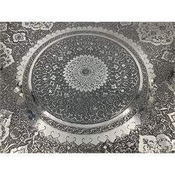 Early/mid 20th century Persian silver tea service, comprising circular serving tray, teapot, twin handled sucrier and cover, milk jug, five tea glasses with six silver holders, six tea spoons, and pair of sugar tongs, each profusely chased with foliate arabesque decoration, each bearing marks including 84 for 840 fineness, tray D40cm, teapot H16cm
