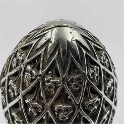 Modern silver limited edition Easter egg, no. 70/500, the openwork lattice body decorated with gilded panels of flower heads, opening to reveal a gilt interior, upon silver stand with three scrolling pad feet, each hallmarked St James House Company, London 1979, height including stand 8cm