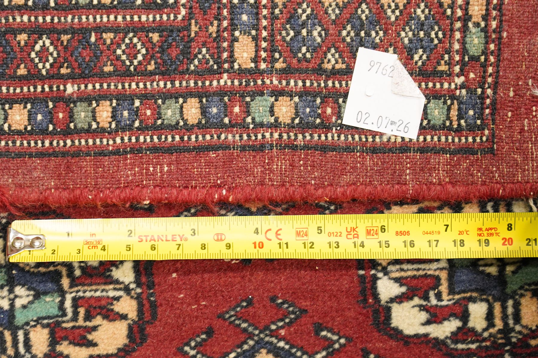 Two hand-knotted rugs, comprising Turkoman Ersari rug and Bokhara rug, Turkoman Ersari hand-knotted rug, terracotta ground with two rows of repeating octagonal guls interspersed with geometric motifs, enclosed by multiple geometric borders, fringed ends, H125cm, W93cm; Bokhara hand-knotted rug, madder red ground with three rows of repeating Tekke guls interspersed with geometric motifs, enclosed by multiple stylised floral and geometric borders, fringed ends, H188cm, W126cm