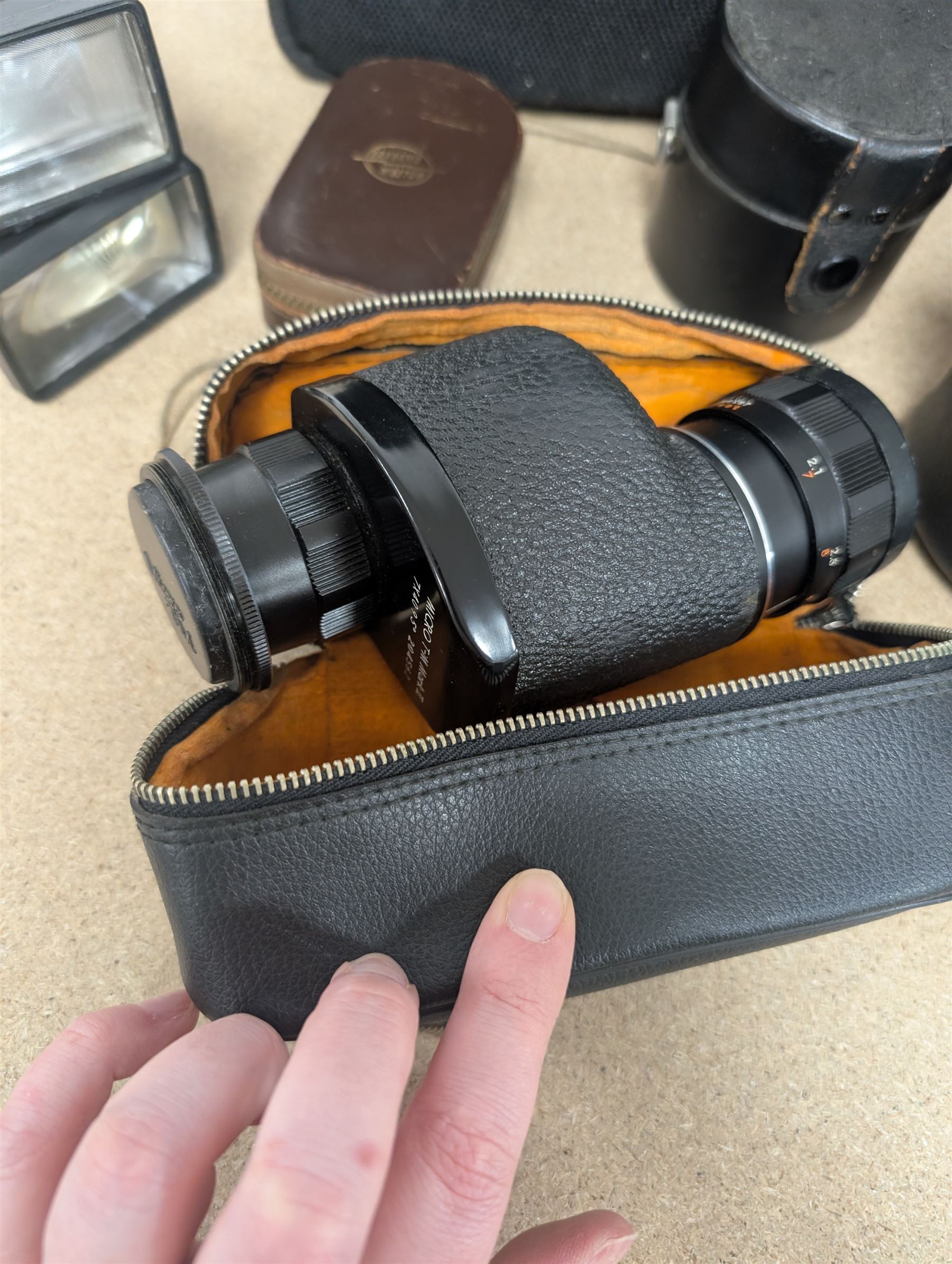 Kodak Dakon II folding camera and a collection of camera lenses and accessories, including Reflex-Nikkor  1:8 f=500mm, NikoN AF Nikkor 70-300mm 1:4-5.6G, Micro TM monocular lens and Teleshot adapter, two cases, Weston exposure meter, two cases etc