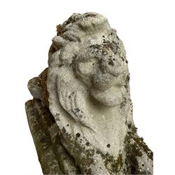 Weathered cast stone recumbent lion, on stepped rectangular base 