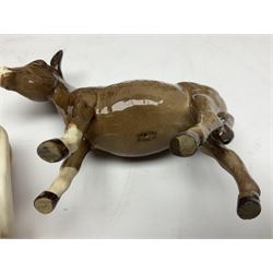 Four Beswick horse figures, comprising Quarter Horse, two Shires no 818 and matt palomino, together with Beswick donkey and Royal Doulton horse on a wooden plinth  