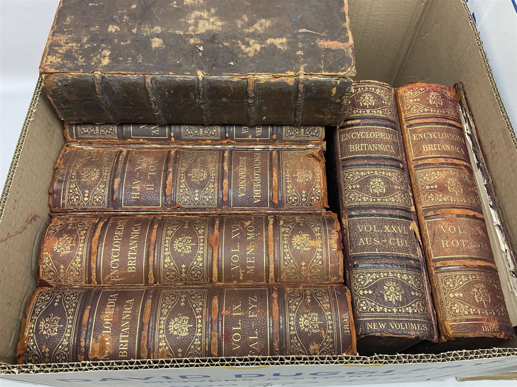 Thirty six volumes of Encyclopaedia Britannica with gold tooled red leather spines in various editions 