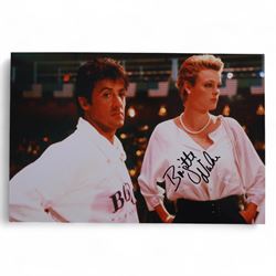 Four Sylvester Stallone film stills and promotional shots, including one depicting Rocky Balboa in the ring, three signed by Sylvester Stallone and one signed by Brigette Nielsen, all with certificates of authenticity