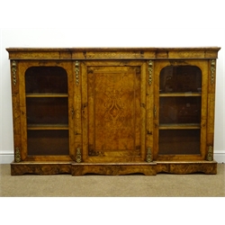  Victorian inlaid figured and burr walnut breakfront credenza, central panel door inlaid with satinwood scrollwork, enclosed by two glazed doors, cast ormolu mounts and boxwood inlay, on a skirted base W181cm, H111cm, D38cm  