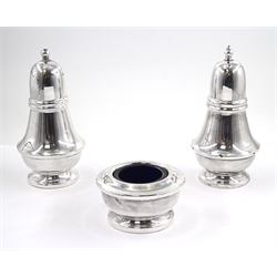 Modern silver three piece cruet set, comprising open salt, of circular form, upon circular spreading foot, with blue glass liner and pepper and matching salt shaker, of typical plain form, upon circular spreading foot hallmarked P H Vogel & Co, Birmingham 1986, approximate total silver weight 6.04 ozt (187.8 grams)