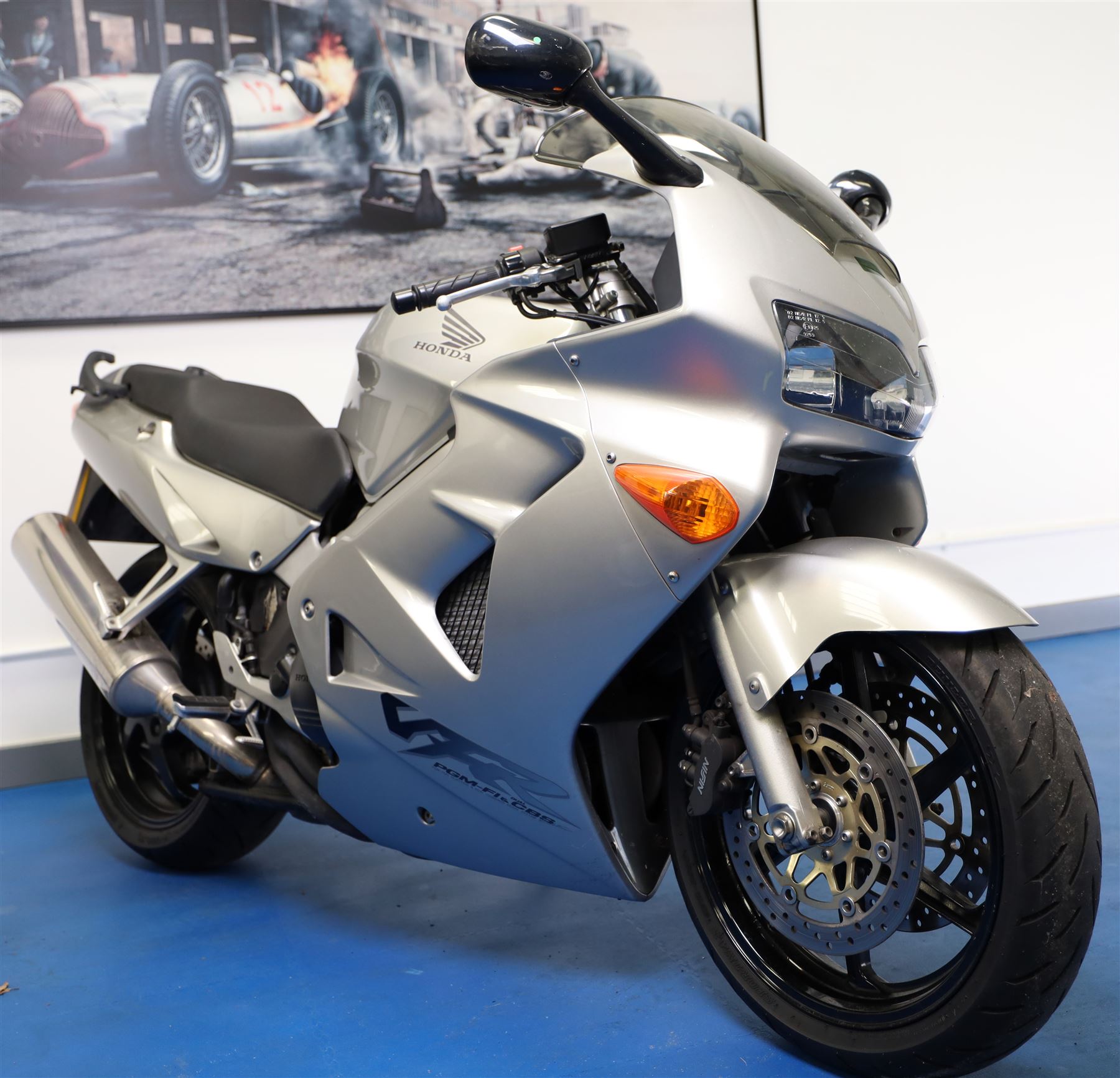 1998 Honda VFR800 FI Sports Touring Motorcycle

• Registration: R145 SUT
• Date of first registration: 1998
• Engine: 781cc V4 petrol
• Fuel system: Honda PGM-FI fuel injection
• Transmission: Manual
• Odometer reading: 11,700 miles
• Colour: Silver with black trim
• V5C: Present
• Keys: Two
• Security: Datatag immobiliser

A well-presented 1998 Honda VFR800 FI sports touring motorcycle, finished in silver with contrasting black trim and displaying a notably low odometer reading of 11,700 miles.

The VFR800 combines Honda’s renowned V4 engine with PGM-FI fuel injection and a combined braking system, creating a capable and refined motorcycle suited to both sporting and long-distance use.

Features include:

• Full factory fairing
• Tinted windscreen
• Honda PGM-FI fuel injection
• Combined braking system
• Twin front brake discs
• Factory exhaust system
• Alloy wheels
• Rear passenger grab handles
• Datatag immobiliser
• Digital instrument display

The motorcycle appears complete and largely original and has been stored indoors. It is presented in good overall condition, with light cosmetic marks consistent with its age and use.

This vehicle forms part of the Estate of the Late John Sils and is offered for sale by the Executors, confirming a genuine reason for sale.
